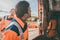 Two garbagemen working together on emptying dustbins