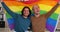 Two gay men holding lgbt flag