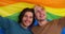 Two gay men holding an lgbt flag