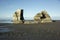 Two Giant Rocks On A Black Sand Beach