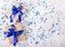 Two gift boxes with blue ribbons on a white background with sparkles. Copy space