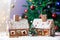 Two gingerbread houses, tree and people sitting on a bench, winter scene