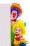 Two girl clowns holding empty text board