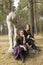 Two girl friends sitting near the destroyed sots art monument in the old Park. Nature.