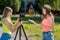 Two girl friends. Summer in nature. Friendly communication. Concepts of the interview. Record vlog and blog subscribers