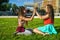 Two girl friends with zizi cornrows dreadlocks giving high five to each other