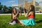 Two girl friends with zizi cornrows dreadlocks giving high five to each other