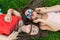 Two girl friends with zizi cornrows dreadlocks lying on green lawn