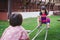 Two girl siblings playing teeter totter rocking with joy. Asian child have sweet smile. Children laughed brightly.