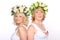 Two girlfriends blonde women in wreaths, smiling, standing backs