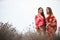 Two girlfriends in colorful scarf clothes, outdoors portrait.