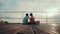 Two girlfriends feeding each other relaxing by the pond sitting on the edge of a wooden pier. Joyful summer day of