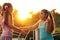 Two girlfriends girls talking on the street at sunset. Schoolgirls , two girls on vacation