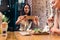 Two girlfriends having healthy lunch in cafe. Young woman taking picture of food with smartphone posting on social media