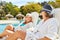 Two girlfriends relax by the pool