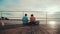 Two girlfriends relaxing by the pond sitting on the edge of a wooden pier. Joyful summer day of friends.