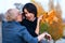 Two girlfriends talking and posing in autumn city park. Beautiful adult woman, blond and brunette