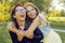 Two girlfriends are walking in the park. Sisters having fun at sunset, jumping, smiling, looking at the camera. Two fashionable