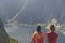 Two girls admire the mountains and the lake