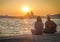 Two girls admire the scenic sunset over Santa Maria della Salute in Venice