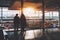 Two girls in airport terminal near window