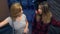 Two girls, Asian and Caucasian, chat in the evening on the street of the modern city. standing on the escalator.