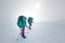 two girls with a backpack and snowshoes walk in the snow during a snow storm