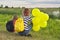 Two girls with balloons back in nature, children near the lake