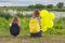 Two girls with balloons back in nature, children near the lake