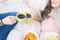 Two girls on bed drinking talking, drinking coffee, eating snacks