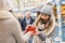 Two girls best friends giving presents on christmas market