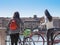 Two girls with bike looking at the river in Verona