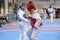 Two girls in blue and red Taekwondo equipment