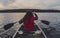 Two girls canoeing with silver canoe on lake in canada algonquin national park on a sunny cloudy day