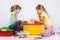 Two girls collect a house on a box with toys