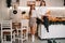 Two girls in a cozy home environment in the kitchen with champagne in their hands for Christmas. Smiling girls drink champagne on