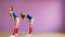 Two girls dance modern dances. Women in swimsuits and leg warmers