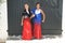 Two girls dancing flamenco. They are in a symmetrical position with the typical handkerchief and the castanets