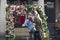 Two girls do selfie with a self-stick around the arch of artificial roses at Covent Garden