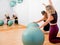 Two girls doing pilates in front of a mirror