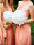 Two girls in dresses holding huge paper white flowers