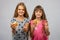 Two girls eat bread and show class