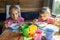 Two girls eat buckwheat with milk from plastic disposable tableware on a train