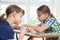 Two girls enthusiastically collect puzzles at the table at home