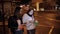 Two girls in the evening at the bus stop drinking coffee and use smartphones.