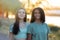 Two girls friends in the countryside walking near a river