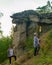 Two girls friends of tourists with a bottle of water in his hand are at the attractions of Yakutia sand mushrooms errosion