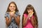 Two girls are funny eating bread