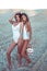 Two girls girlfriends bodysuit bathing suits, sunbathe summer sand sea. Stand beach, tourist. Rest ocean, style fashion