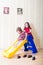 Two girls having fun atop playground slide